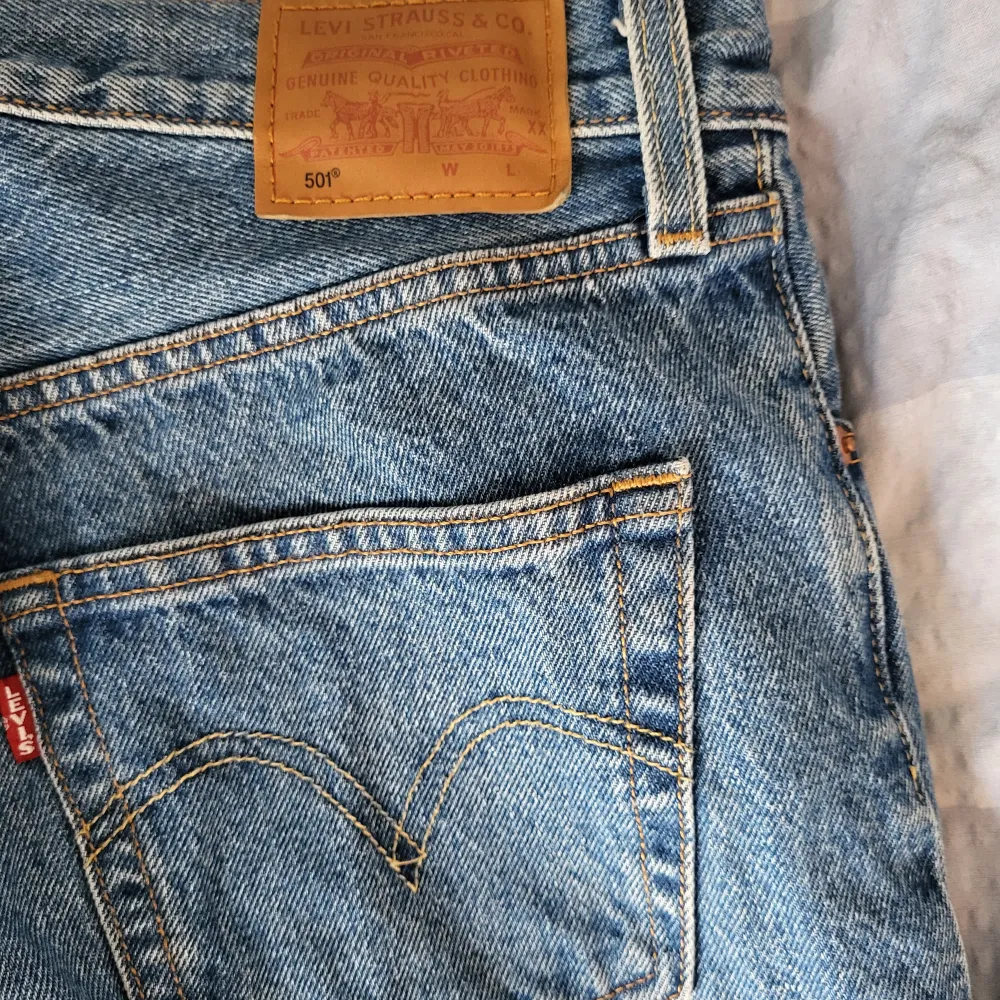 Ett par klassiska blå Levi's 501 jeans i storlek W26 L30. Dessa jeans har en rak passform och är tillverkade av denim. De har fyra fickor och en knappgylf.. Jeans & Byxor.