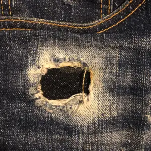 Blåa Dsquared2 jeans shorts. Snygga till sommaren som snart är här, säljer de pågrund av att de är för små. Det finns lite defekter som ni kan se på bilden där trådarna har lossnat vid hålet och därför säljer jag för billigt pris.