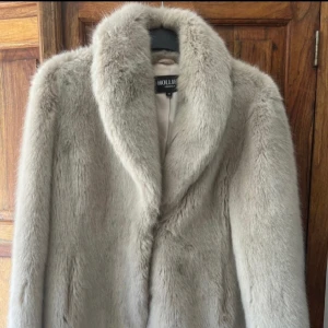 Pälsjacka  - Gråbeige jacka från Hollies. Bra skick då den endast är använd vid få tillfällen.