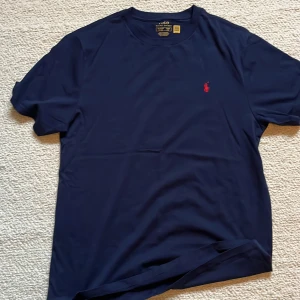 Ralph lauren T-shirt  - En riktigt fet Ralph Lauren T-shirt som knappt kommer till användning och är i ett perfekt skick 10/10. Nypris:949kr Vårt pris: 449kr