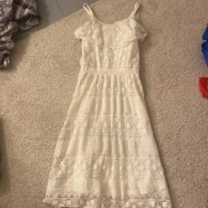 Vit klänning  - En mysig somrig klänning som inte använts mer än 3 gånger! Den har volanger och en söt smyckning! 