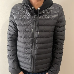 J.Lindeberg jacka - Tja, säljer just nu denna jättesnygga och populära J.Lindeberg dunjacka. Den är i storleken M och är i bra skick förutom ett hål på insidan av jackan  (bild 3). Nypris är runt 2500kr och vårt pris är endast 1099kr. 