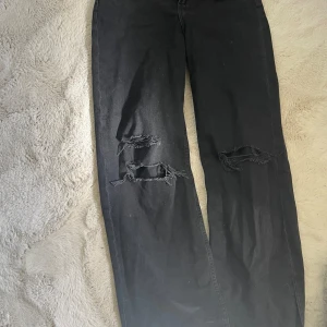 Svarta Jeans - Vida svarta jeans med hål på knäna. Kan ha tecken på användning på knäna i hålen då smörerna har fått lite sönder💖vid frågor kontakta mig! Pris kan diskuteras!