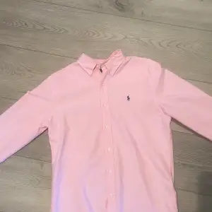 Säljer denna rosa och stilrena skjorta ifrån Ralph Lauren eftersom den är för liten. Skicket är vänligt bra då den inte har kommit till så mycket användning. Storleken är M
