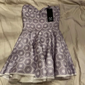 Kort klänning  - Kort klänning utan ärmar men har gummi runt som håller den uppe. Från axparis har aldrig använt men har nån fläck i som jag inte har nån anning om hur dom kom ditt kan va att den hängt i rummet nåt år. Skriv om ni har någon fråga❤️