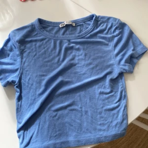 Blå Zara T-shirt - En blå Zara tröja. strl S men är liten i strl så kan vara xs och xxs. Kommer inte till användning 