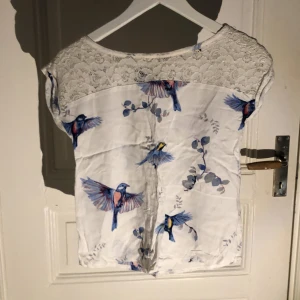 Vit blus med fåglar  - En fin vit blus med fåglar på. Har nästan aldrig använt. Tröjan har ett bra skick 💗