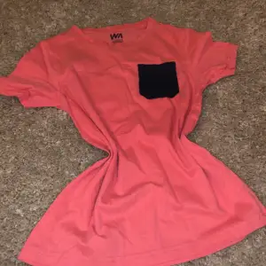 Coral red t-shirt with a navy pocket 