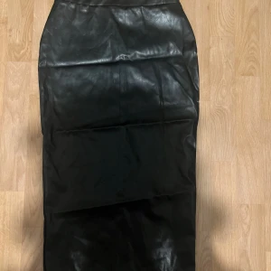 Läderkjol  - Tajt midikjol i läderimitation. Bra skick. 