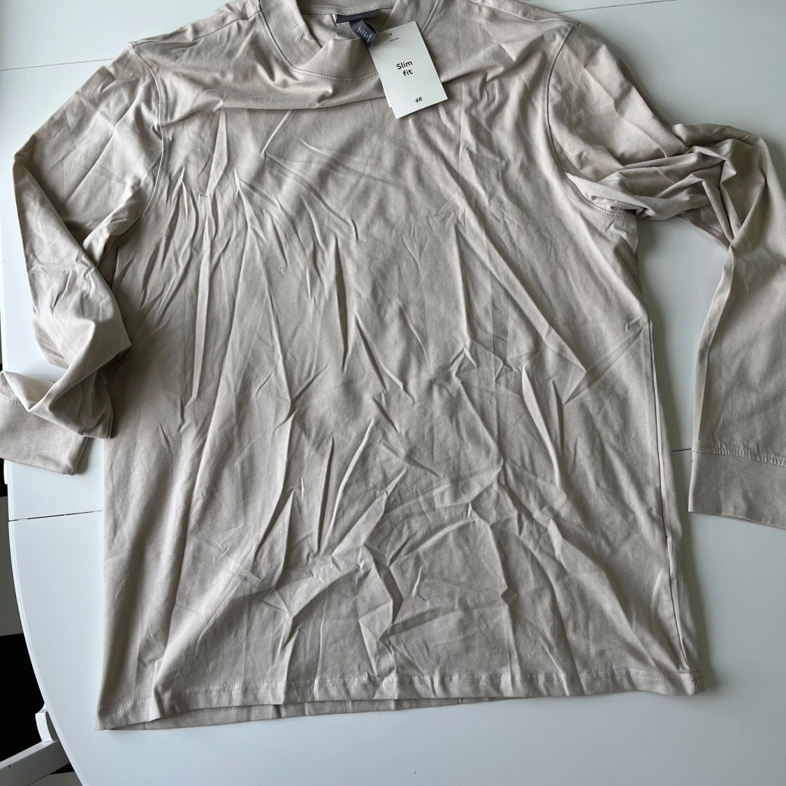 Långärmad stretchy slimfit-tröja från HM