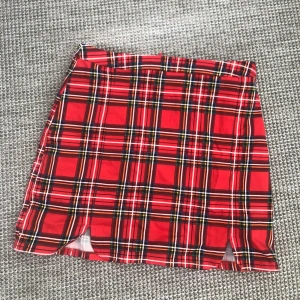 Rutig kjol - Rutig kjol från Divided, aldrig använd. Fina slitsar och formar fint. Säljer då den aldrig kommer till användning ❤️