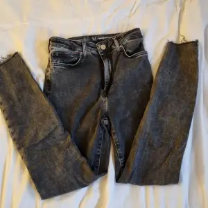 Acid washed jeans, extremt stretchiga, från bikbok, hål vid knäna och trådat längst ner vid anklarna, dragkedja och knapp. 