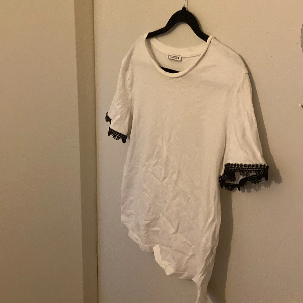 En Sara T-shirt i vit med svart spets på kanterna i storlek M andvänt Max 3 gånger lite skrynklig för han legat i garderoben då den inte passar säljer för 130kr💕 går att pruta💕💕. T-shirts.