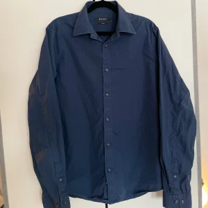 Marinblå skjorta Tiger of Sweden  - Marinblå skjorta herr från Tiger of Sweden. Storlek borta men ca 40. Fint begagnat skick.