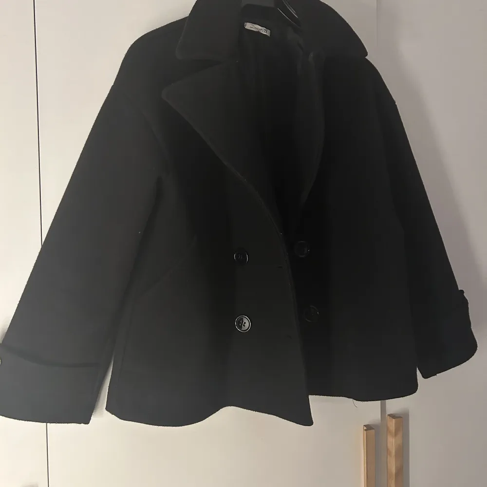 Säljer denna super fina svarta kappa från design by si i storlek XS/S. Säljer till ett billigare pris då den är nopprig på vissa ställen som ni kan se på bild 3. Utöver de skulle jag säga att den är i fint skick. Ordinarie pris 750kr. Jackor.