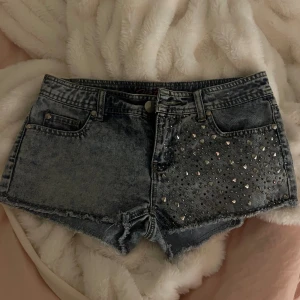 lågmidjade jeans shorts - skitsnygga lågmidjade jeansshorts med nitar/strass på. köpta förra sommarn secondhand, alldrig använda pga att de nt passade. skulle säga att det är strl s elr 36 då jag brukar behöva xs elr 34🤍🤍