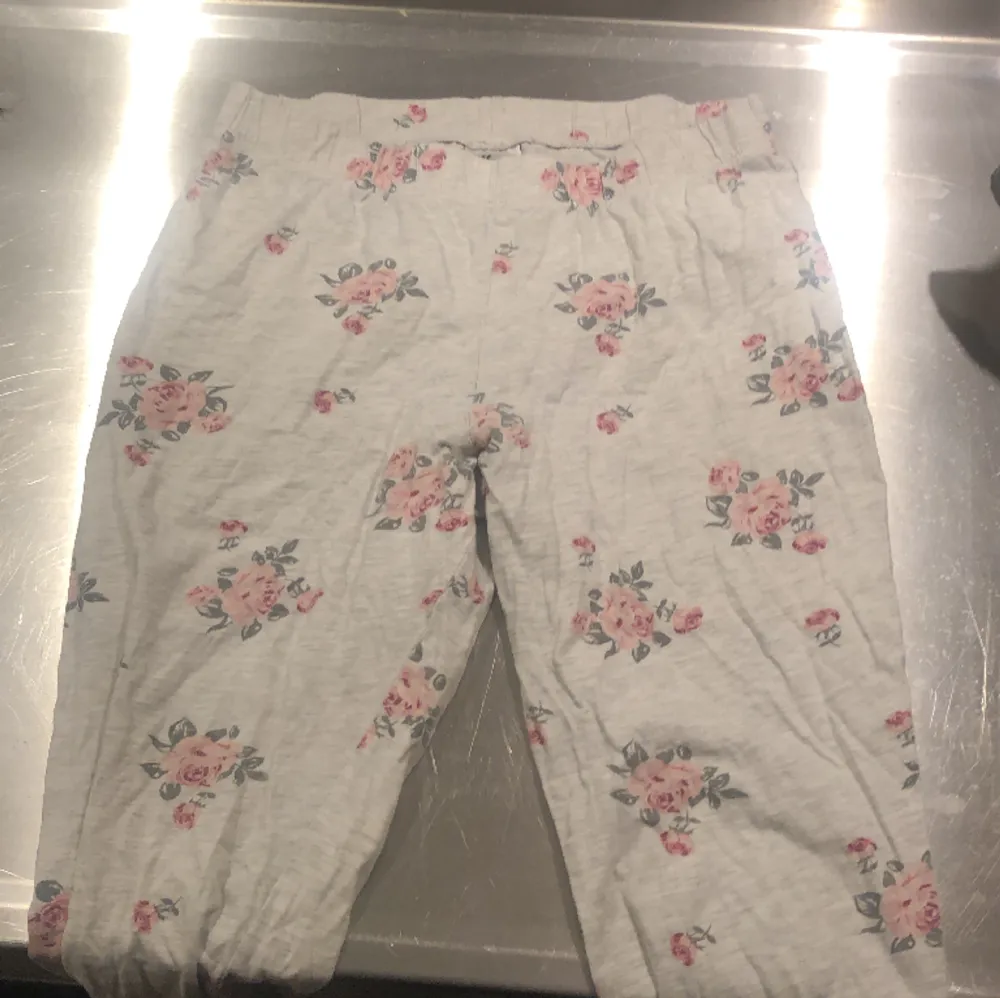 Ett par blommiga pyjamasbyxor som inte kommer till användning . Jeans & Byxor.