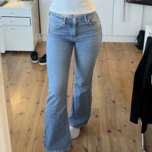 Blå jeans - Ljusblå utsvängda jeans med midwaist från gina tricot. Säljer då de är lite för korta på mig som är 174cm lång. 