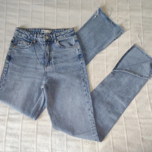 Ljusa slit jeans - Gina Tricot - storlek 34 - Ljusa raka jeans med slits nertill. Långa i benen (går såklart ta av dem på längden om man vill) och hög midja. Så snygga och bekväma. Storlek 34. 99% bomull, 1% elastan.