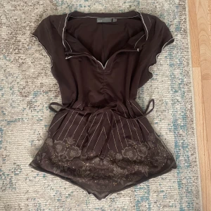 söt topp - en söt brun topp från märket mexx! supervackra detaljer med vit söm runt ärmarna och halsringen🥰lite trekantig passform längst ned på plagget, baksidan är formad likadant🫶har snören så man kan knyta den fram eller bak så blir toppen mer kroppsformad💞