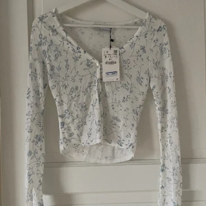 Zara topp - Så fin topp från zara som passar perfekt nu när våren är på väg🩵 den är tunnt stickad vilket gör den lite genomskinlig, den har även två knappar som gör att det blir en ”öppning” nertill så det passar bra med en snygg bralette eller topp under🥰