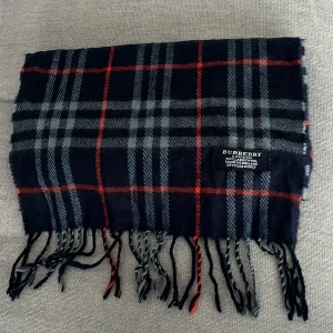 Burberry halsduk  - Snygg rutig halsduk från Burberry. Tillverkad i 100% lamm ull. Självklart äkta!
