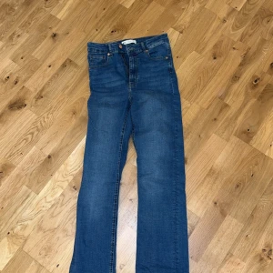 Blå jeans från Geerfect Jeans - Snygga blå jeans från Ginatricot, modell Molly. De har en klassisk design med knapp och dragkedja framtill. Slits längst ner vid benen. Storlek M