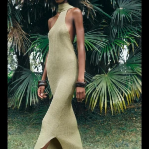 Olivgrön stickad klänning - Snygg olivgrön stickad klänning med halterneck och öppen rygg. Klänningen har en lång passform och en liten slits framtill. Perfekt för en stilren look. Supersnygg men inte riktigt min stil, har haft problem med Zaras returer och kan därför inte returnera den och vill mest bli av med den🥰storlek S men passar fler! Jag brukar ha XS och passar mig galant så materialet är stretchigt! Hade varit så snyggt med ett stort bälte i midjan också!!! Kan gå ner i pris!!