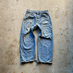 Lee x Weekday jeans - Lee x weekday jeans. De är slitna och har en del lagningar. Baggy passform. Har en acne patch påsytt på baksidan