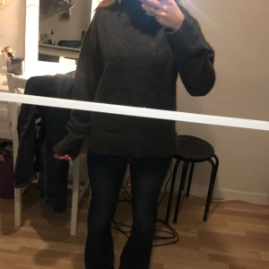 Mörkgrå stickad polotröja - Säljer en mysig mörkgrå stickad polotröja med långa ärmar. Perfekt för kyliga dagar och ger en stilren look. Passar bra till jeans eller kjol.