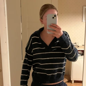  randig tröja i blått och vitt - Säljer en mysig blå tröja med vita ränder. Tröjan har en v-ringad design och långa ärmar. Använd få gånger.