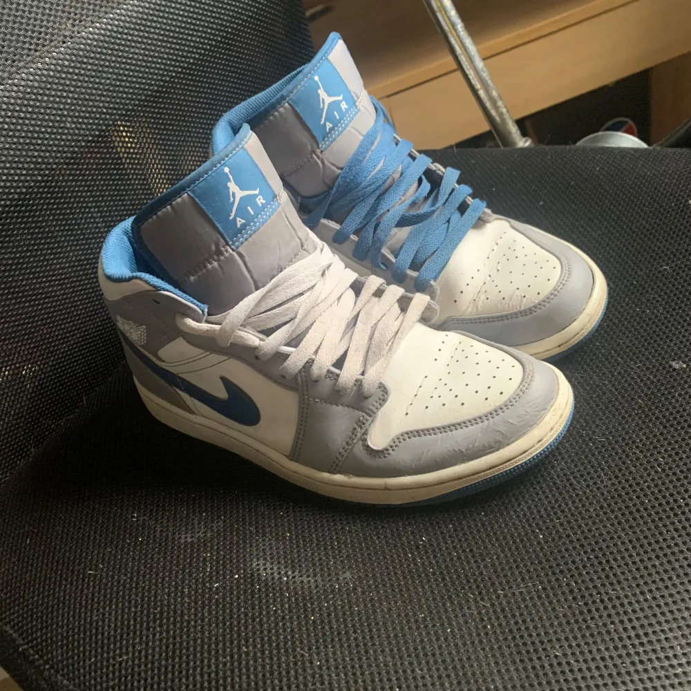 Säljer ett par Nike Air Jordans i blått och vitt. De är lite slitna men har annars ganska bra skick. . Skor.