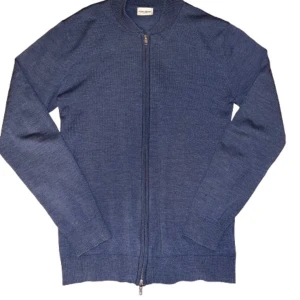 Blå kofta från John Henric  - Säljer en stilren blå kofta från John Henric i mycket bra skick. Den är långärmad och har en praktisk dragkedja framtill. Perfekt för både höst och vår, och passar till många olika outfits. Supermjuk och bekväm! Köpt för 1200