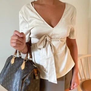 Ljusrosa topp - Ljusrosa topp som knyts i midjan, super fin!!💘💘 går att justera hur hårt den ska sitta och rosetten kan vara både bak eller fram!!💘😊