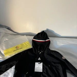 Moncler jacka windbreaker - En helt ny, snygg och fräsch moncler jacka som passar perfekt till hösten, våren och Sveriges sommar. Jackan är helt ny, lapparna finns kvar. NFC skam fungerar. Storlek M. Jag har S men jackan sitter fortfarande bra, så den passar både S och M. 