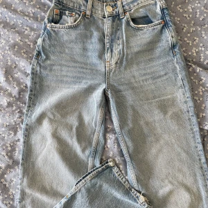 Blåa jenas med slits - Jeans i storlek 32 från Ginatricot, som nya så i väldigt bra skick, slits vid anklarna, inga defekter 