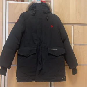 Svart jacka från Canada Goose - Säljer en svart dunjacka från Canada Goose med pälsdetaljer på huvan. Vi köpte den på NK för några år sedan tyvärr så vet vi inte vart kvittot är. Men ni kan vara säker på att den är riktig. PRISET KAN DISKUTERAS!!