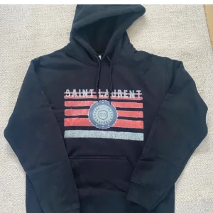 Saint Laurent hoodie  - Extremt eftertraktad och snygg Saint Laurent hoodie, hoodien är i bra skick och utan defekter. Är osäker på äktheten därav priset. Kom privat för frågor! 