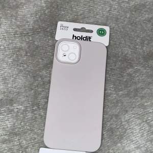 Holdit mobilskal i färg beige, passar för iPhone 14 och 13. Helt oanvänd och säljer den pga att den inte kommer till användning.