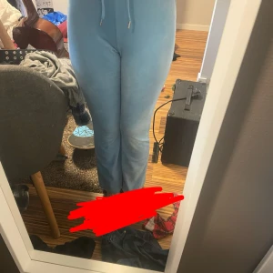 Ljusblå byxor från Gina Tricot - Säljer ett par ljusblå byxor från Gina Tricot. Byxorna har en bekväm passform med snörning i midjan, utsvängda nertill och är tillverkade i ett mjukt material. Perfekta för en avslappnad stil.