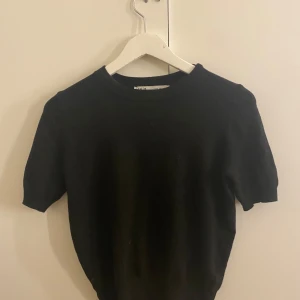 Svart kortärmad tröja från Zara - Snygg och enkel svart tröja från Zara med korta ärmar. Perfekt för en stilren look. Passar bra till både jeans och kjol. 🖤