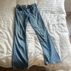 Bootcut ljus blåa jeans. Lite tunnare material i rumpan. Fina fickor där bak med silvriga knappar i  - bra skick men ändå använt några gånger. Tunnare material i rumpan men ändå bra. Skönt material