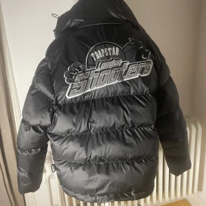 Trapstar Shooters Jacka (kvitto finns) - Säljer denna trapstar jacka då den inte passar mig. Den är storlek Xs och är köpt för runt ett år sen, men helt oanvänd. Jackan är riktigt fet samt svårt att få tag på. Nypris låg på cirka 5500. Kvitto finns även!