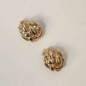 Guldiga flätade örhängen - Snygga vintage clipsörhängen  med ett flätat mönster. Guldfärgad metall Perfekta för att ge en elegant touch till din outfit.