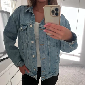 Blå jeansjacka  - Säljer en snygg ljusblå jeansjacka i utmärkt skick från Monki i storlek XXS men passar som en S. Denna jacka har en klassisk design med bekväm passform och är perfekt för alla tillfällen!