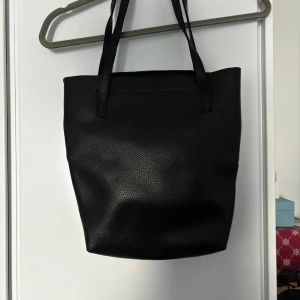 Handväska  - Avlång handväska. Får plats med dator och mappar osv