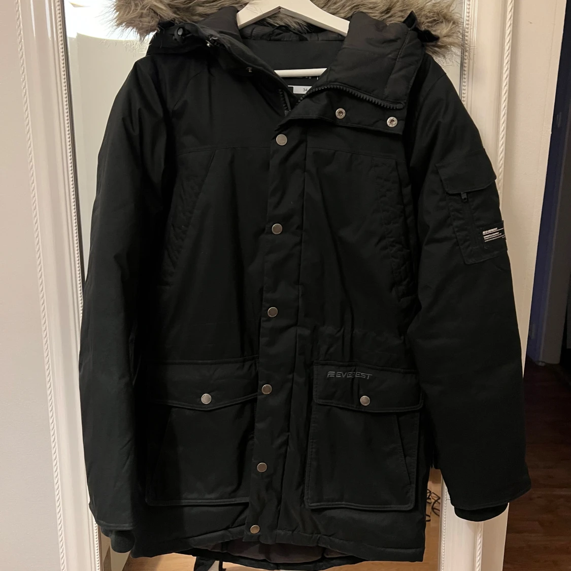 Svart parkajacka med pälsdetaljer