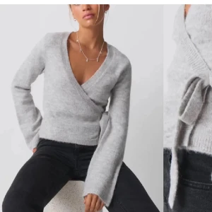 Grå omlottstickad tröja - Säljer den göra  superfina gråa omlottstickade tröja som är super trendig! Perfekt nu till vintern och den är helt slutsåld så passa på! Fick den i present och är helt oanvänd!