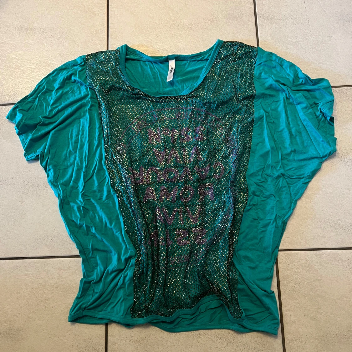 Turkos topp med nät och text