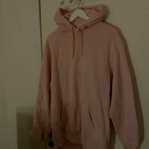 Rosa hoodie från H&M - Säljer en mysig rosa hoodie från H&M i storlek M. Den har en klassisk design med dragsko i huvan och en stor magficka. Perfekt för en avslappnad stil. 